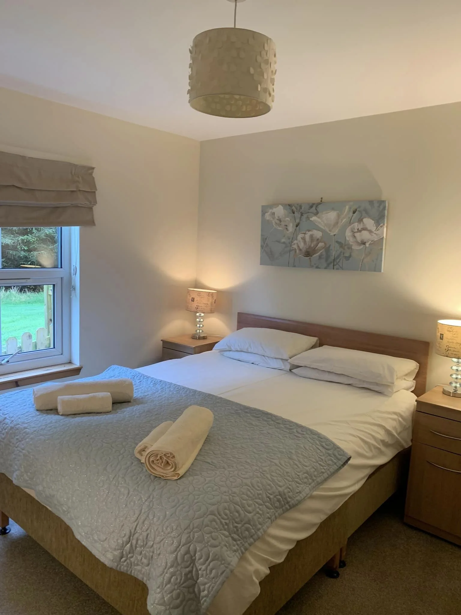 Cozy bedroom with neat bed and soft lighting