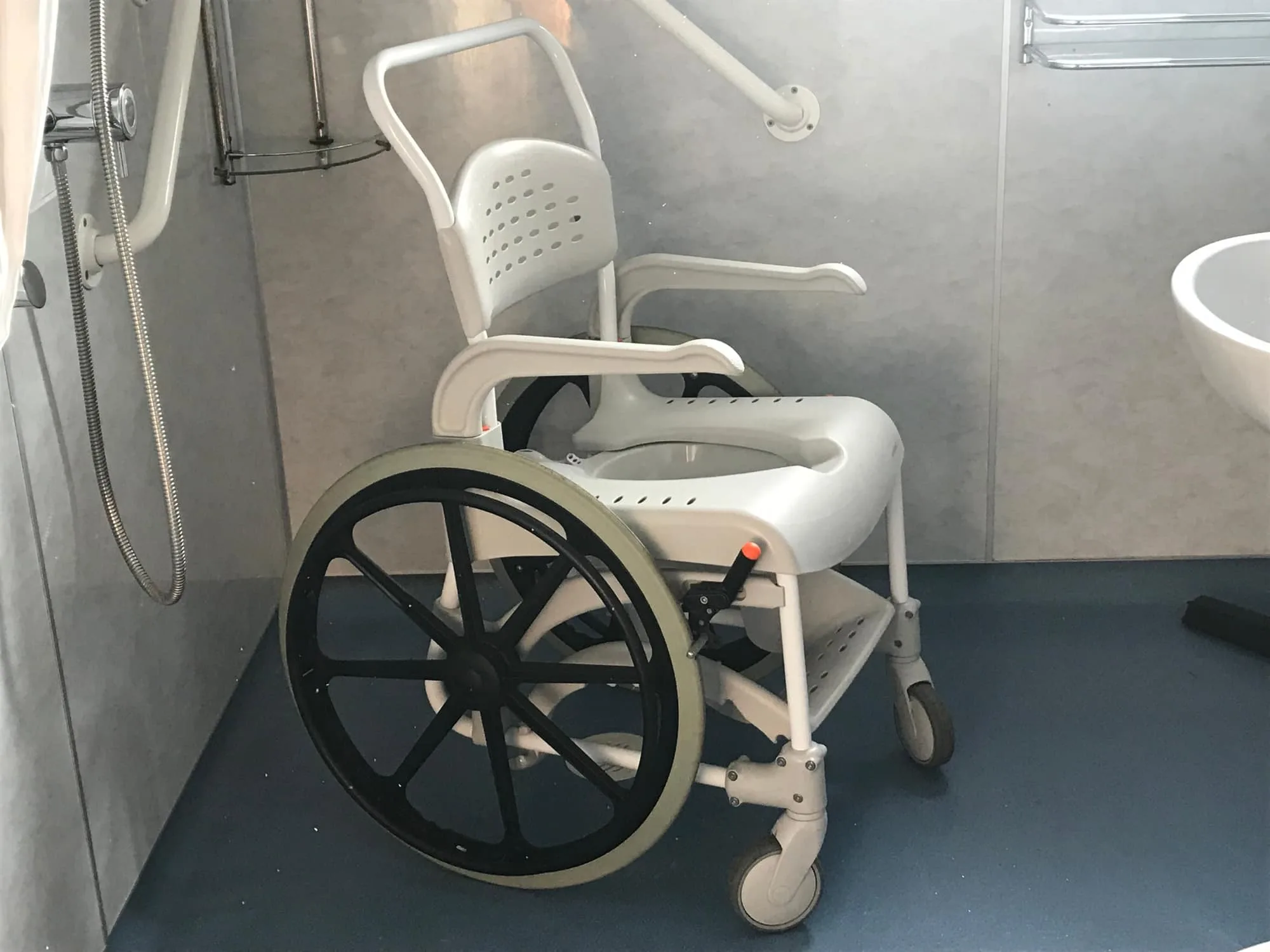 Accessible bathroom with white shower wheelchair