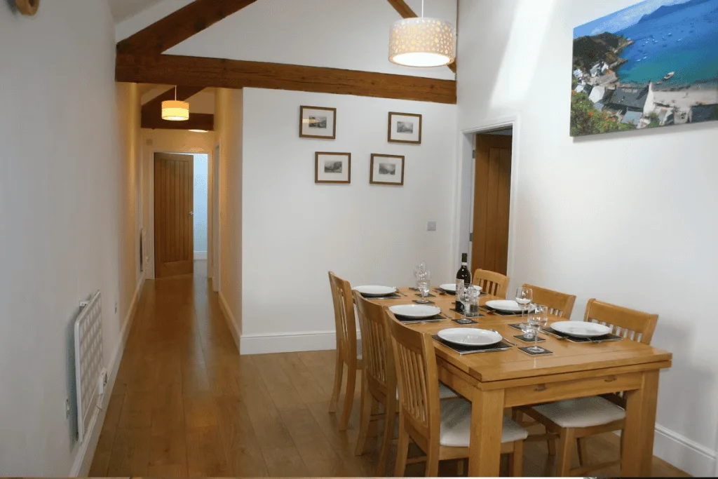 Cozy dining room with wooden table set for dinner