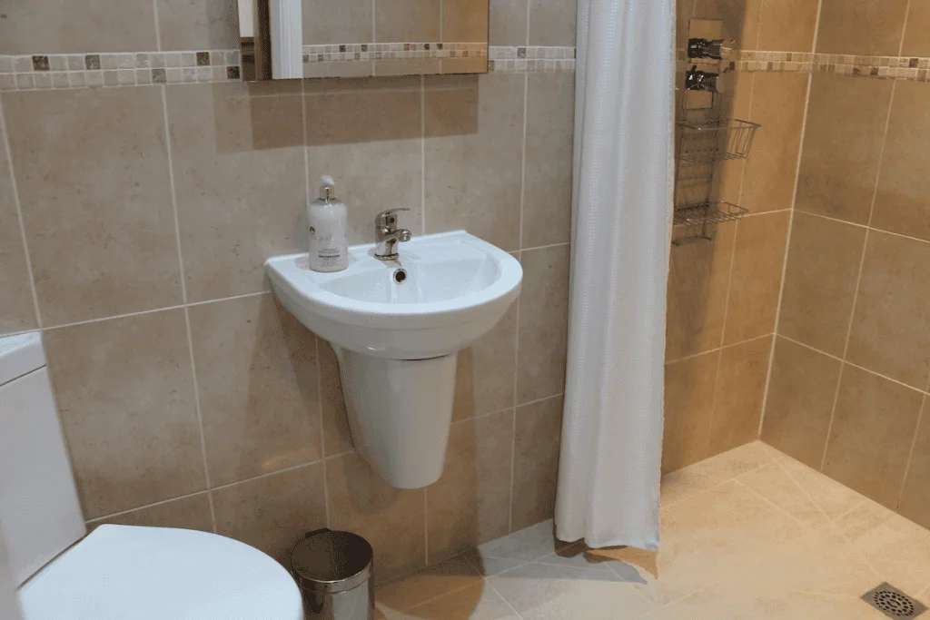 Modern bathroom with sink, shower, and toilet