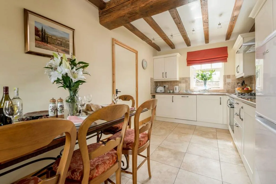 Cozy kitchen with wooden beams and dining table setup