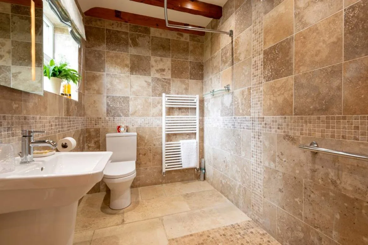 Modern bathroom with tiled walls and natural light