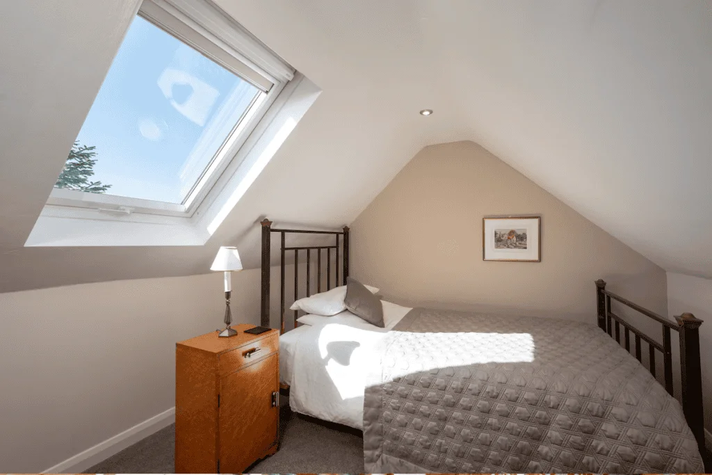 Cozy attic bedroom with skylight and minimal decor