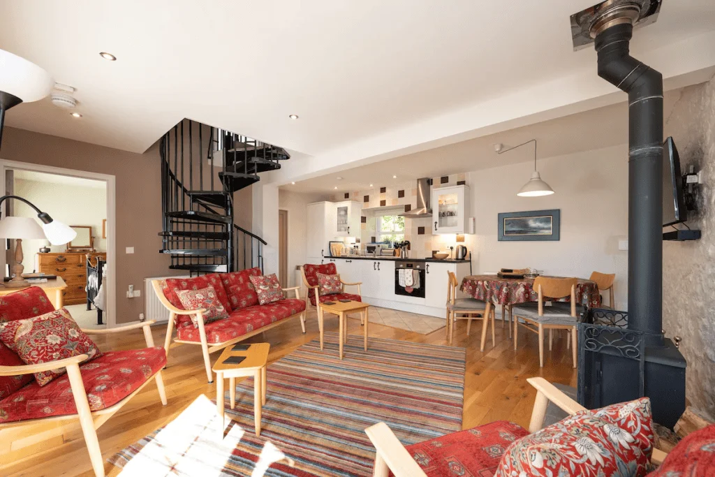 Cozy interior with spiral staircase and red sofas