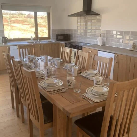 Well-set dining table in bright, modern kitchen