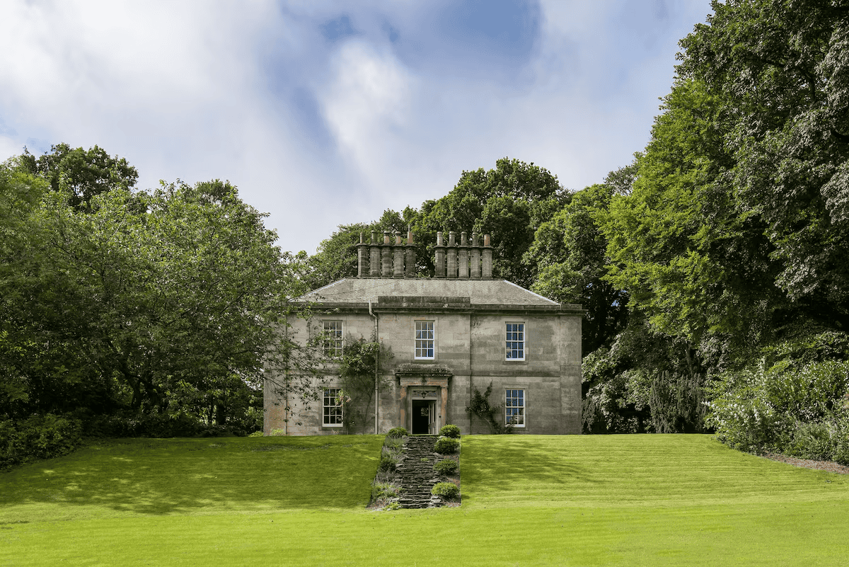 Elegant historic mansion surrounded by lush greenery