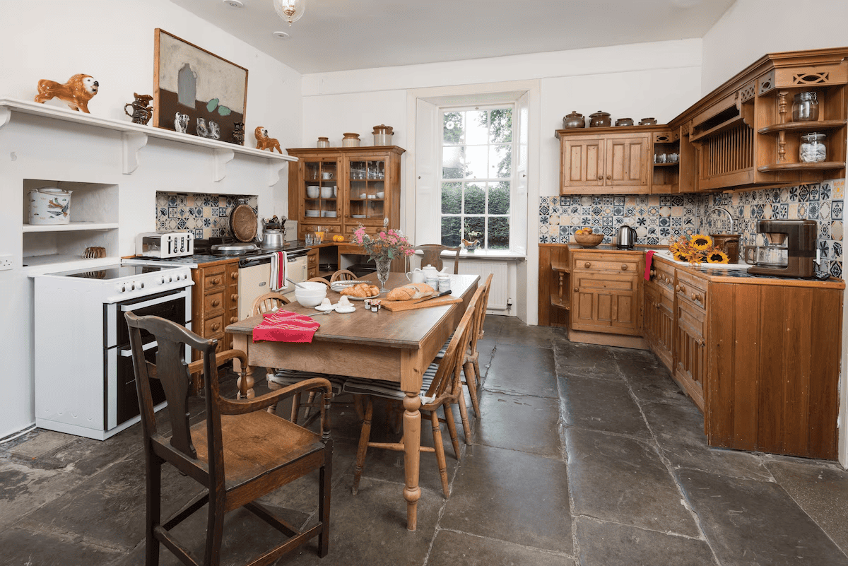 Spacious traditional kitchen with rustic wooden furniture and decor