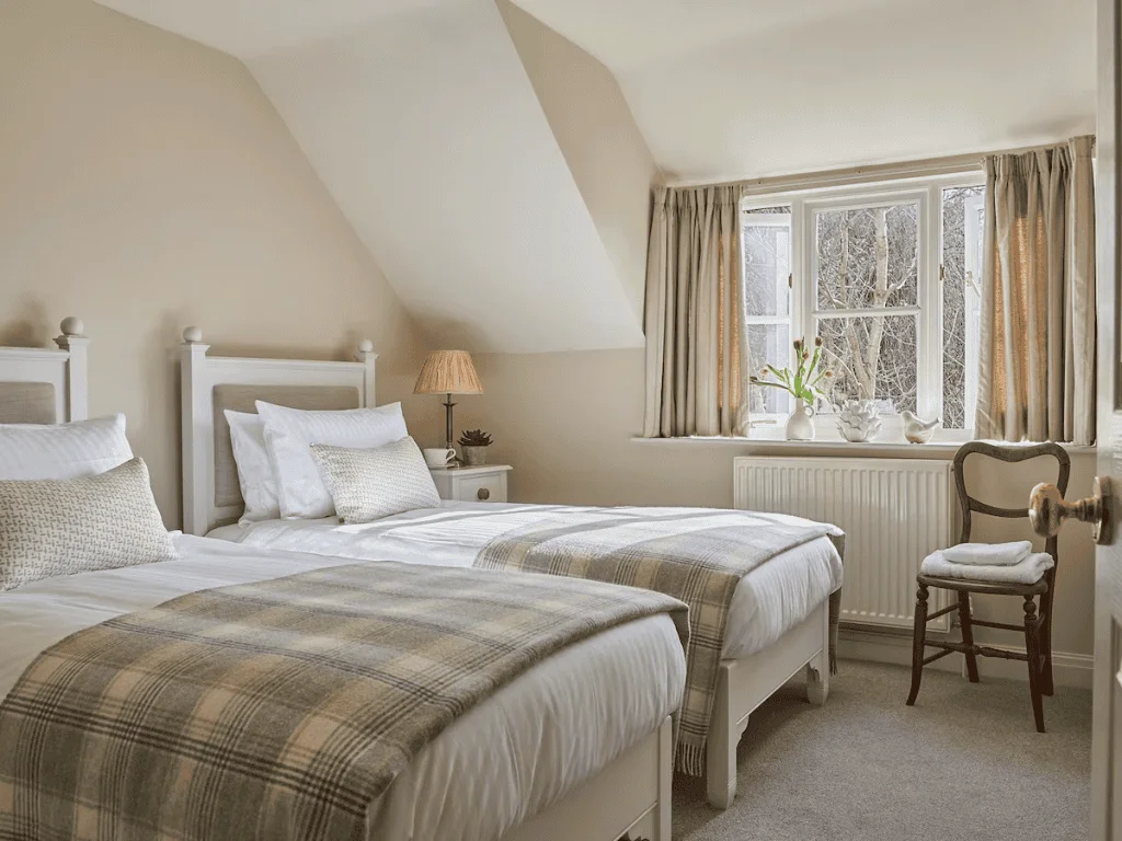 Cozy twin bedroom with plaid blankets and bright window