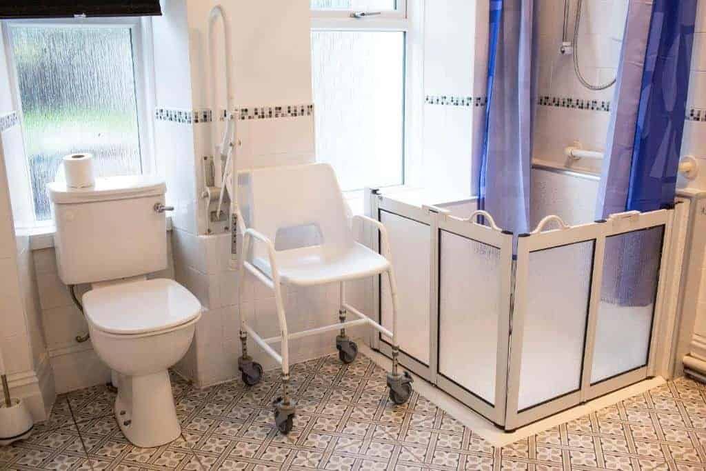 Accessible bathroom with shower chair and safety features