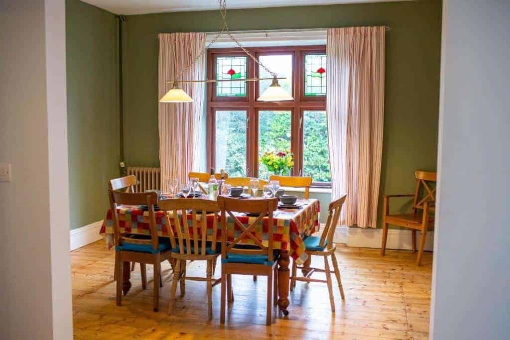 Cozy dining room with colorful chairs and table setting