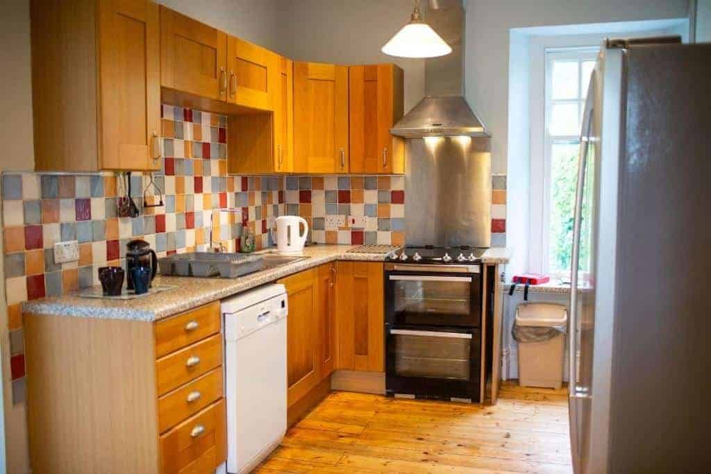 Bright kitchen with wooden cabinets and colorful backsplash