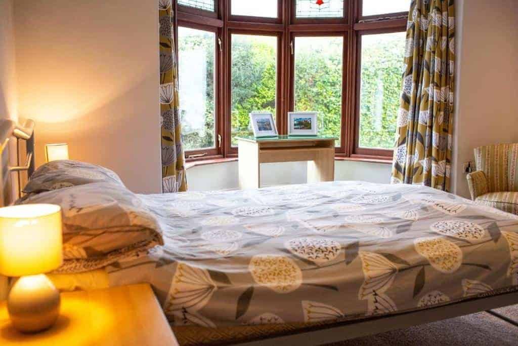 Cozy bedroom with large bed and warm lighting