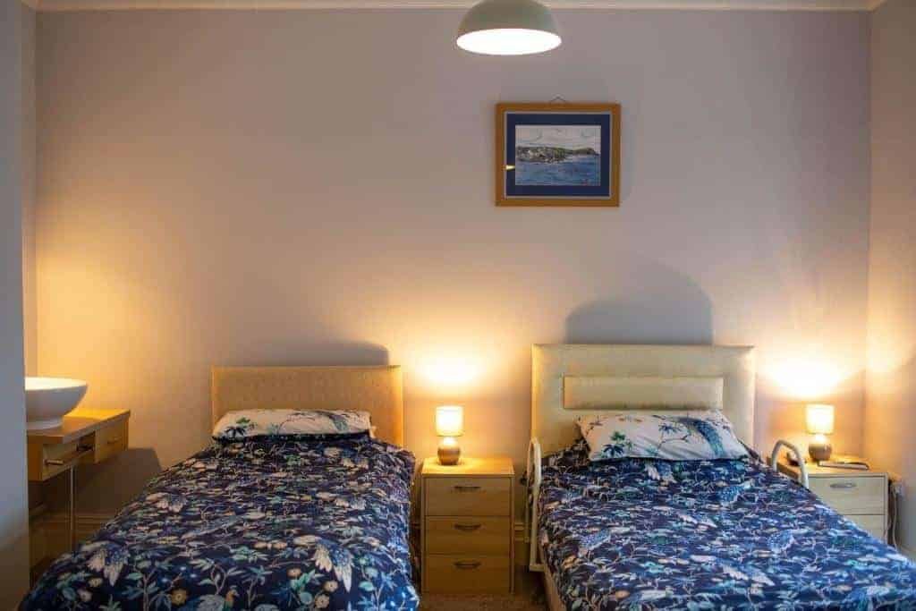Cozy twin bedroom with soft lighting and floral bedding