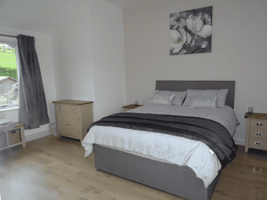 Modern bedroom with floral artwork and window view