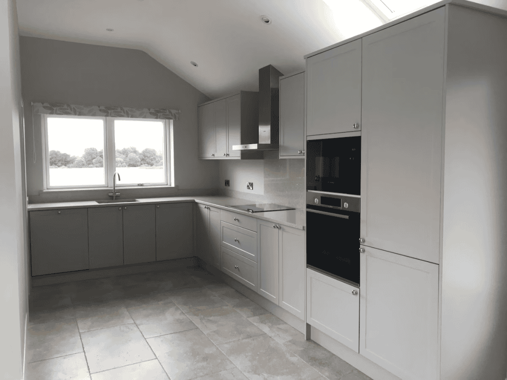 Modern kitchen with gray cabinets and large windows