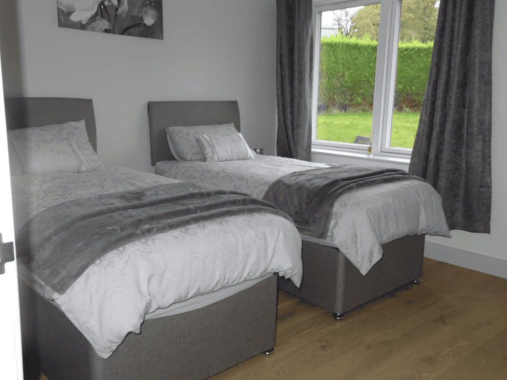 Two twin beds in modern room with garden view