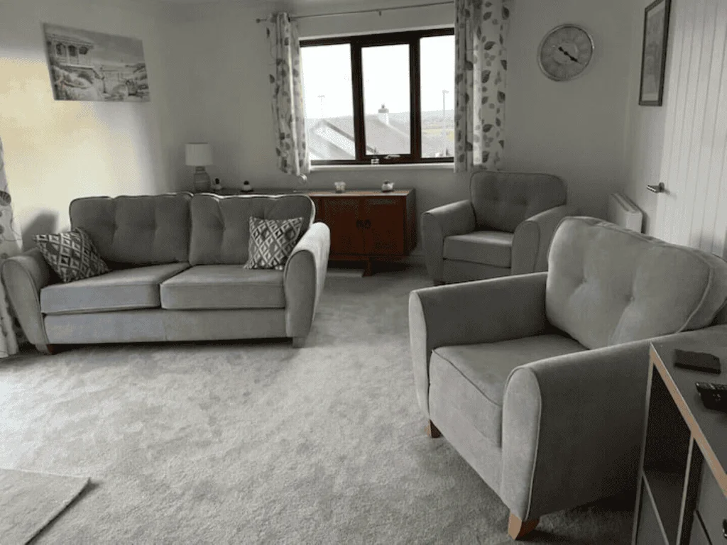 Spacious living room with modern gray sofas and decor