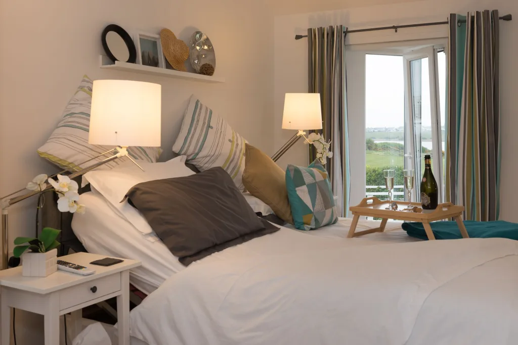 Cozy bedroom with open window view and champagne tray