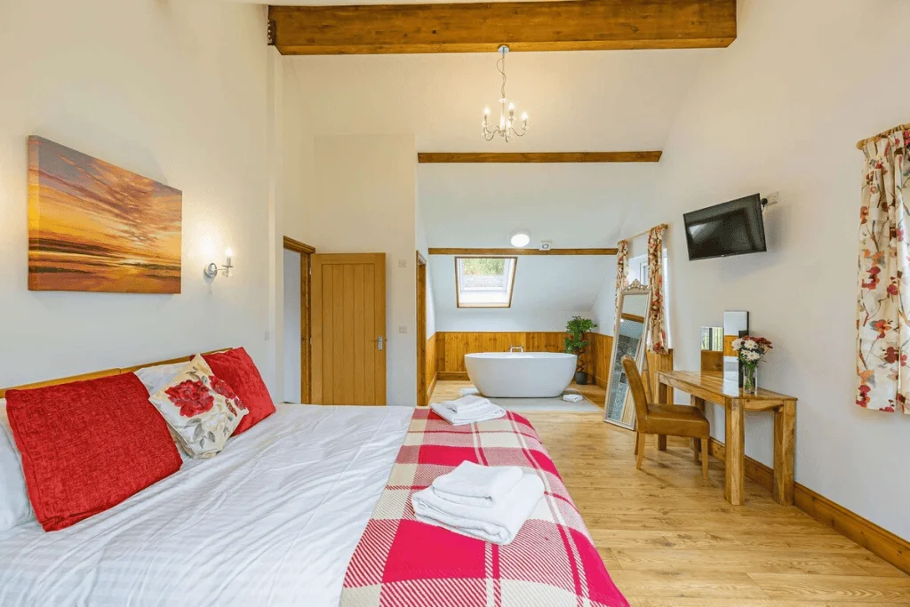 Cozy rustic bedroom with freestanding bathtub and wooden accents