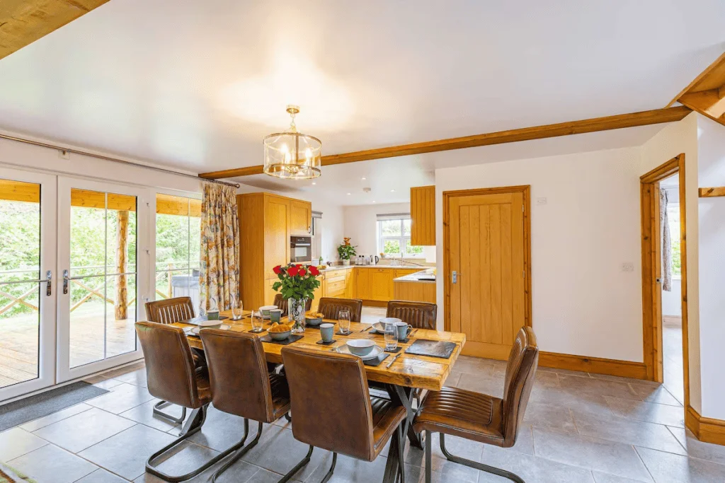 Spacious dining room with wooden furniture and open doors