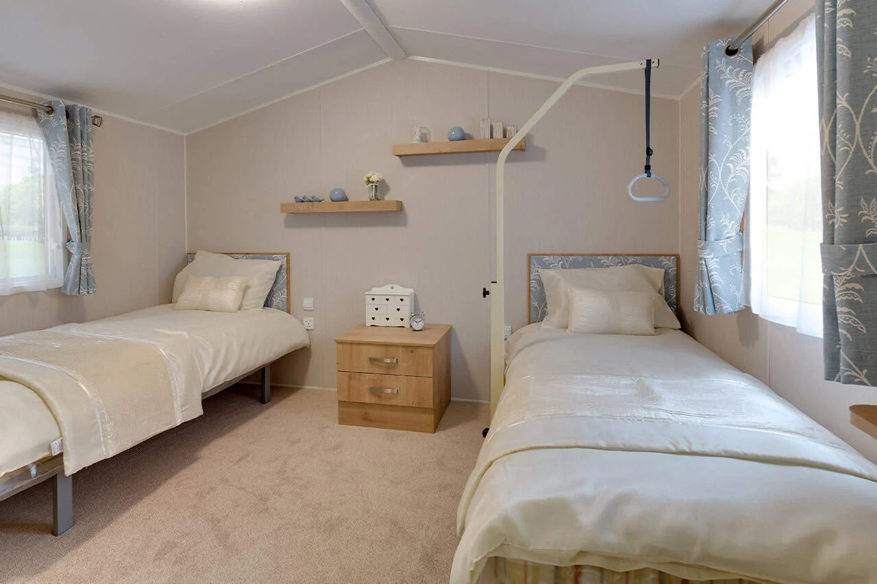 Bright, twin bedroom with modern decor and natural light.