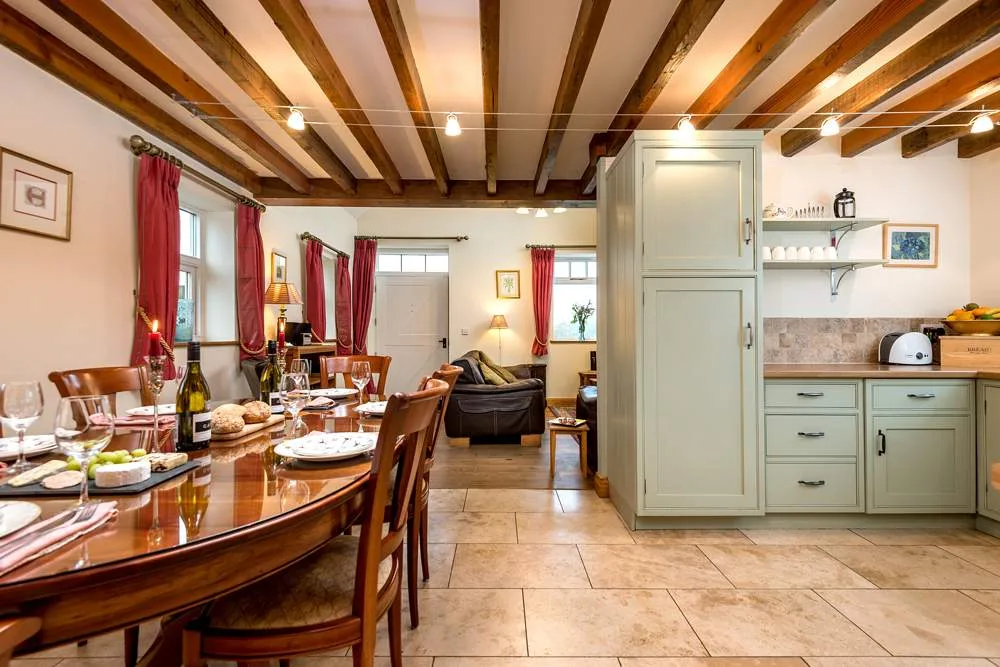 Cozy dining room setup with kitchen area and wine