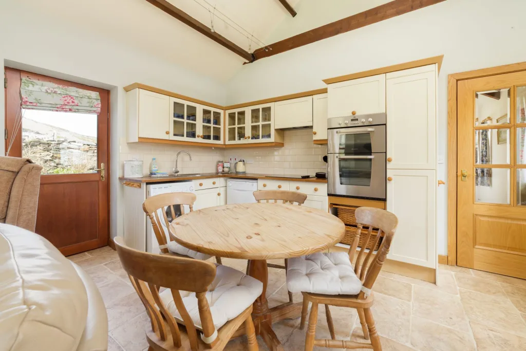 Cozy sunlit kitchen with wooden furniture and modern appliances