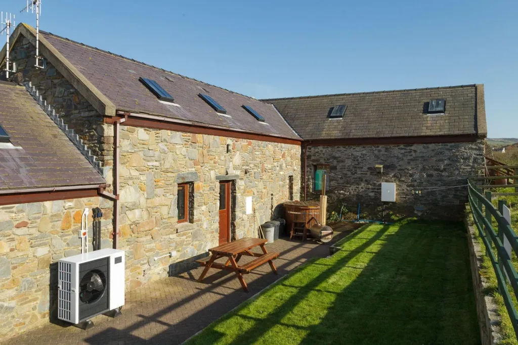 Sunny cottage with lush yard and stone walls