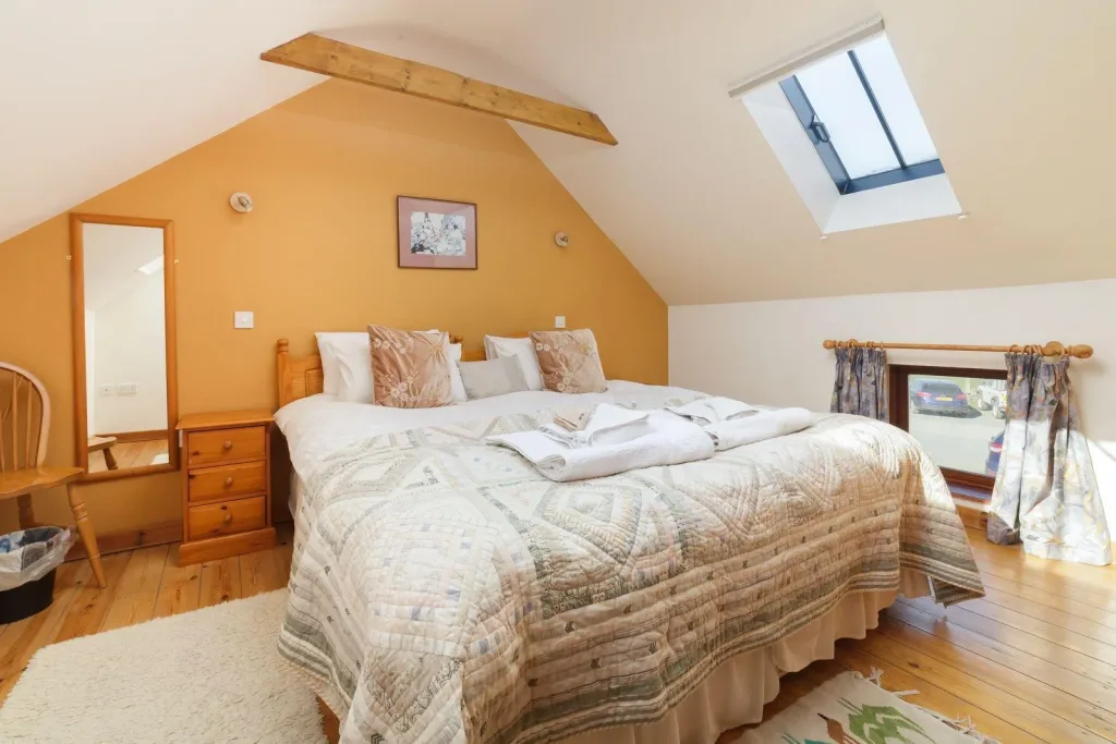 Cozy attic bedroom with skylight and wooden accents
