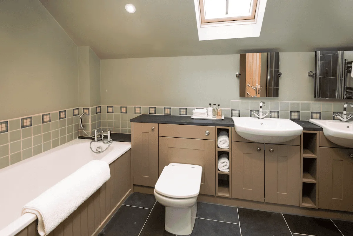 Modern bathroom with dual sinks and skylight