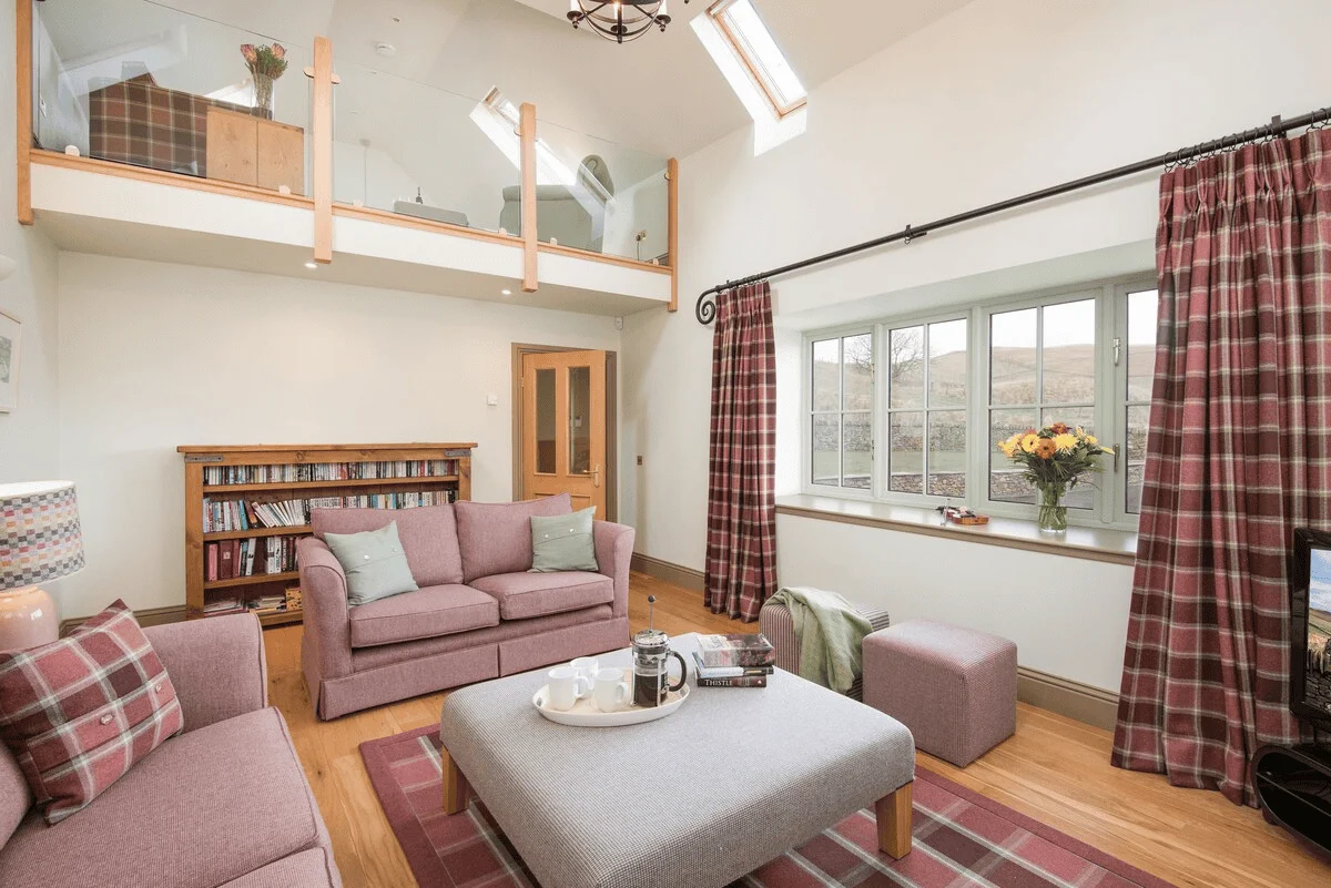 Cozy living room with skylights and rural view