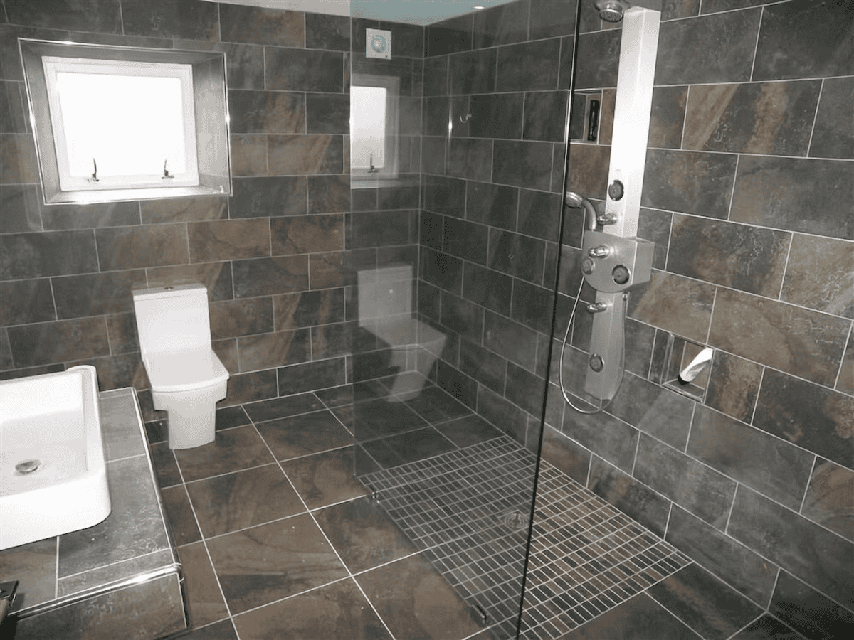 Modern bathroom with tiled walls and glass shower