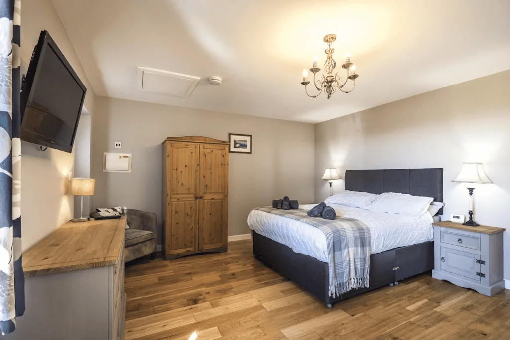 Elegant bedroom with wooden floors and modern decor