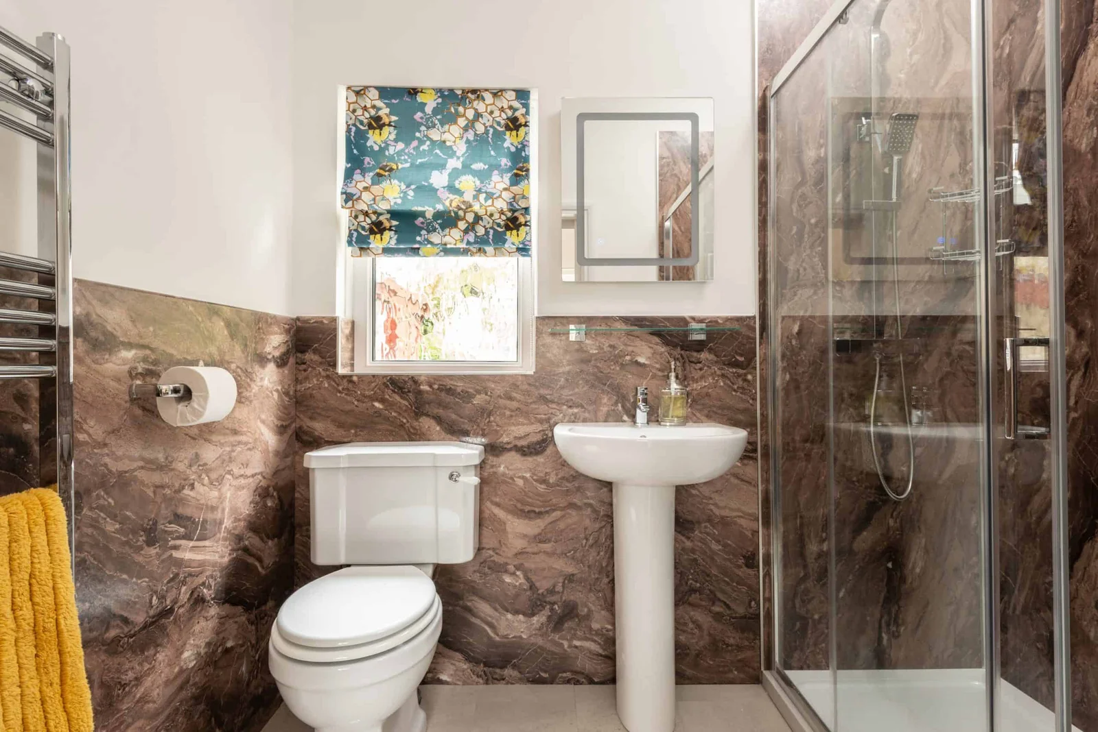 Modern bathroom with marble walls and glass shower