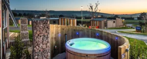 Outdoor hot tub overlooking scenic hillside at dusk