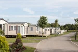 Row of modern caravans in a sunny park setting