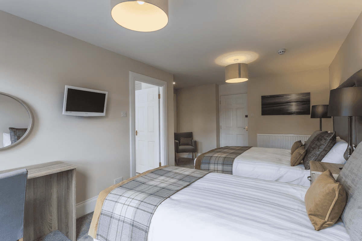 large family bedroom with double bed, single bed and ensuite bathroom