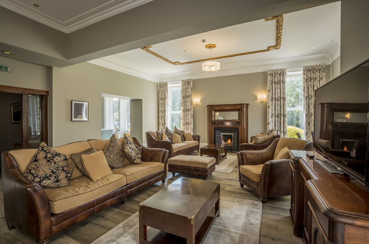 Large living room with multiple sofas and open fireplace