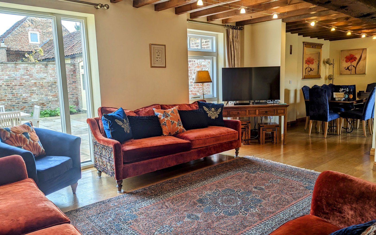 Cosy living room with colourful sofas and rugs.