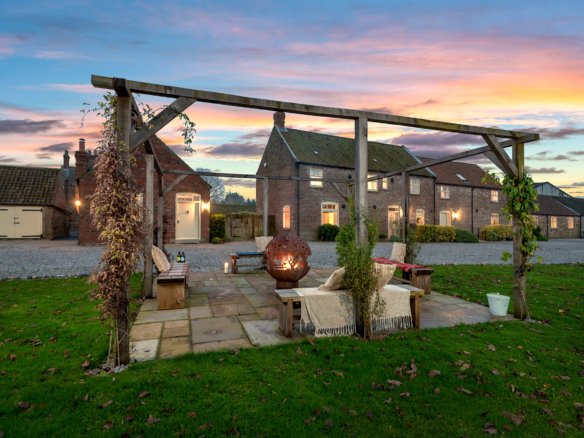 Charming countryside home at sunset, patio and fire pit.