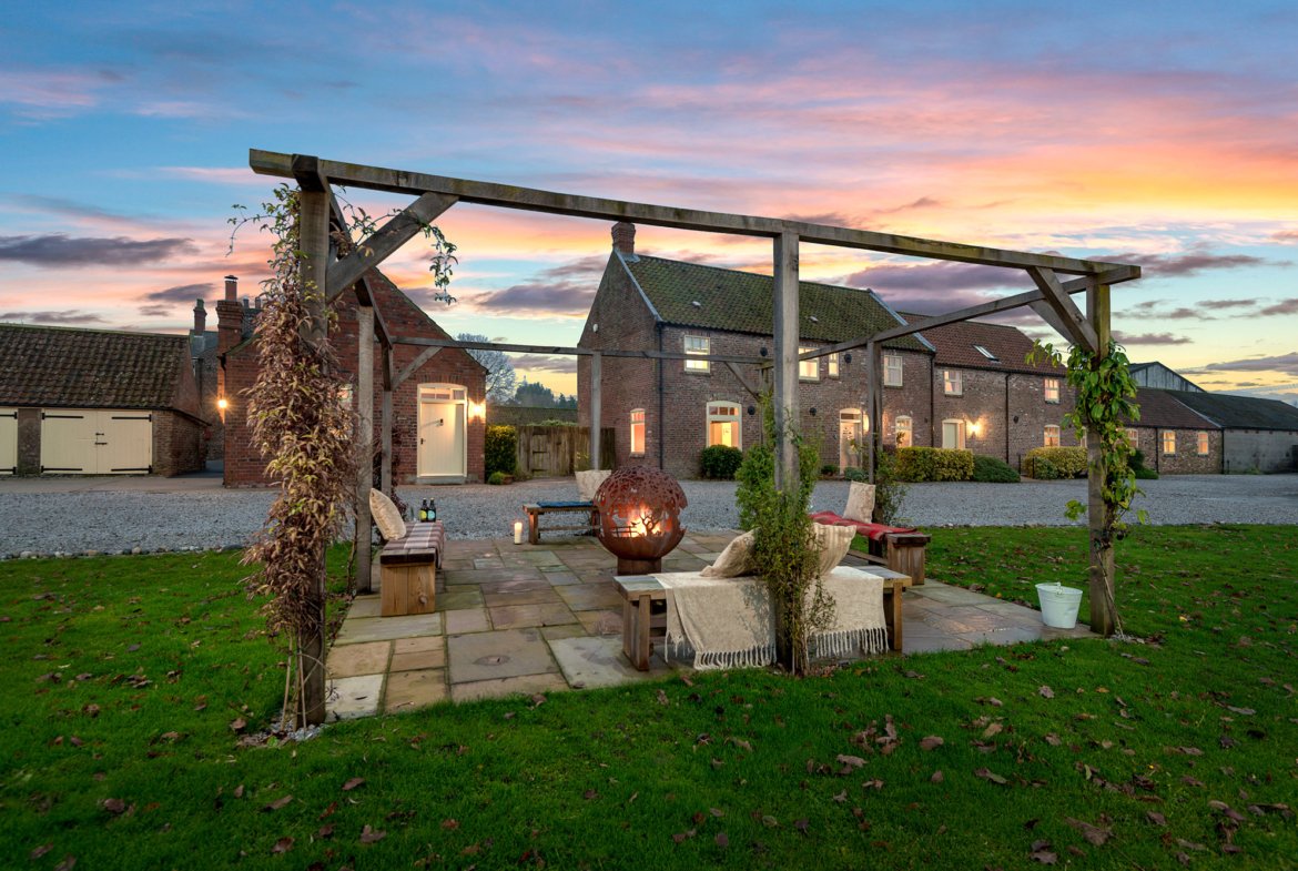 Charming country house at sunset with garden patio.