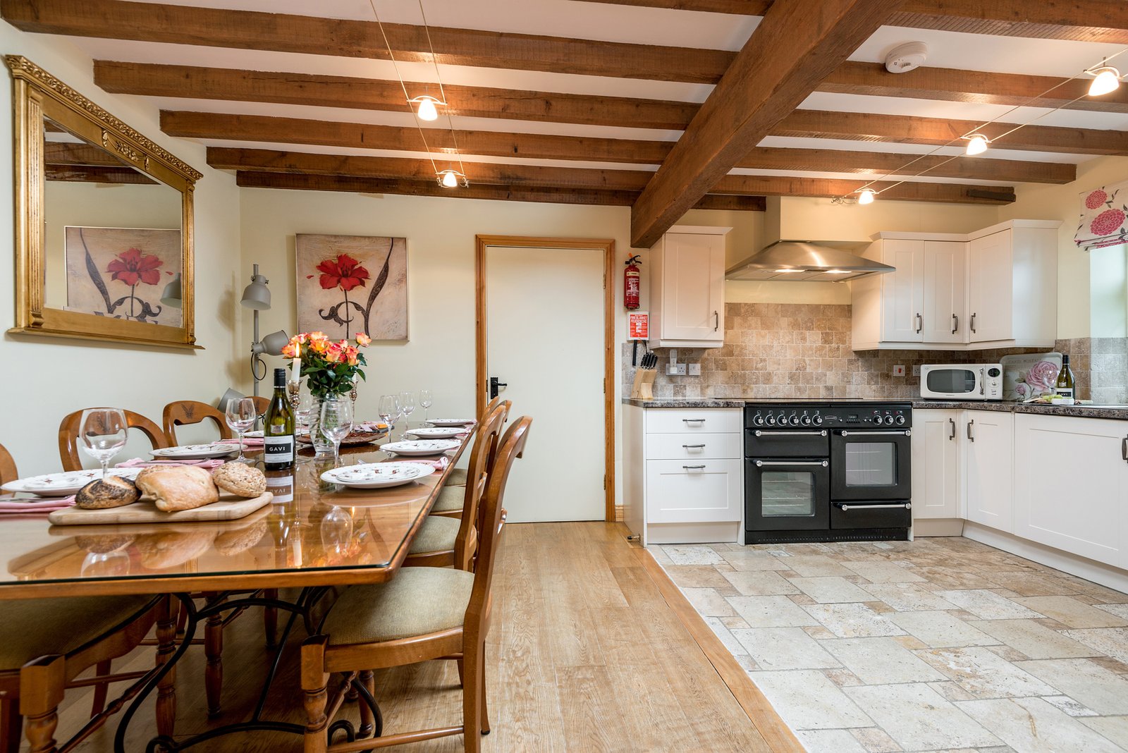 Rustic kitchen with dining table and modern appliances.