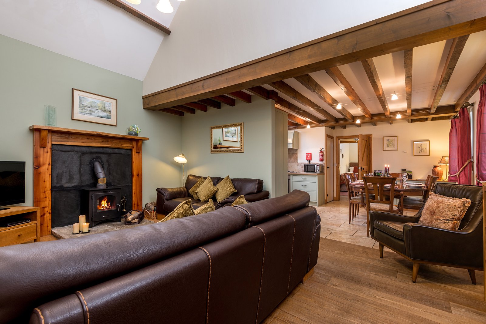 Cosy living room with fireplace and wooden beams.