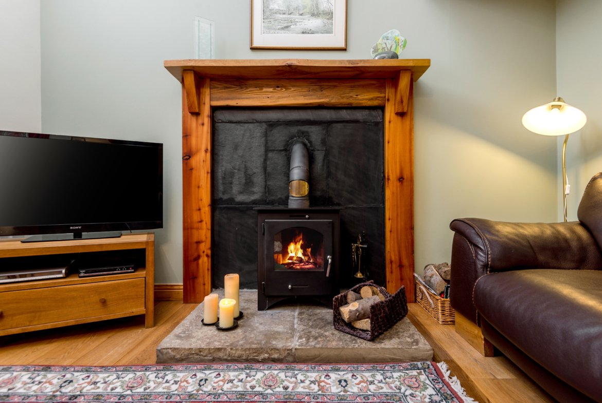 Cosy living room with fireplace and TV.