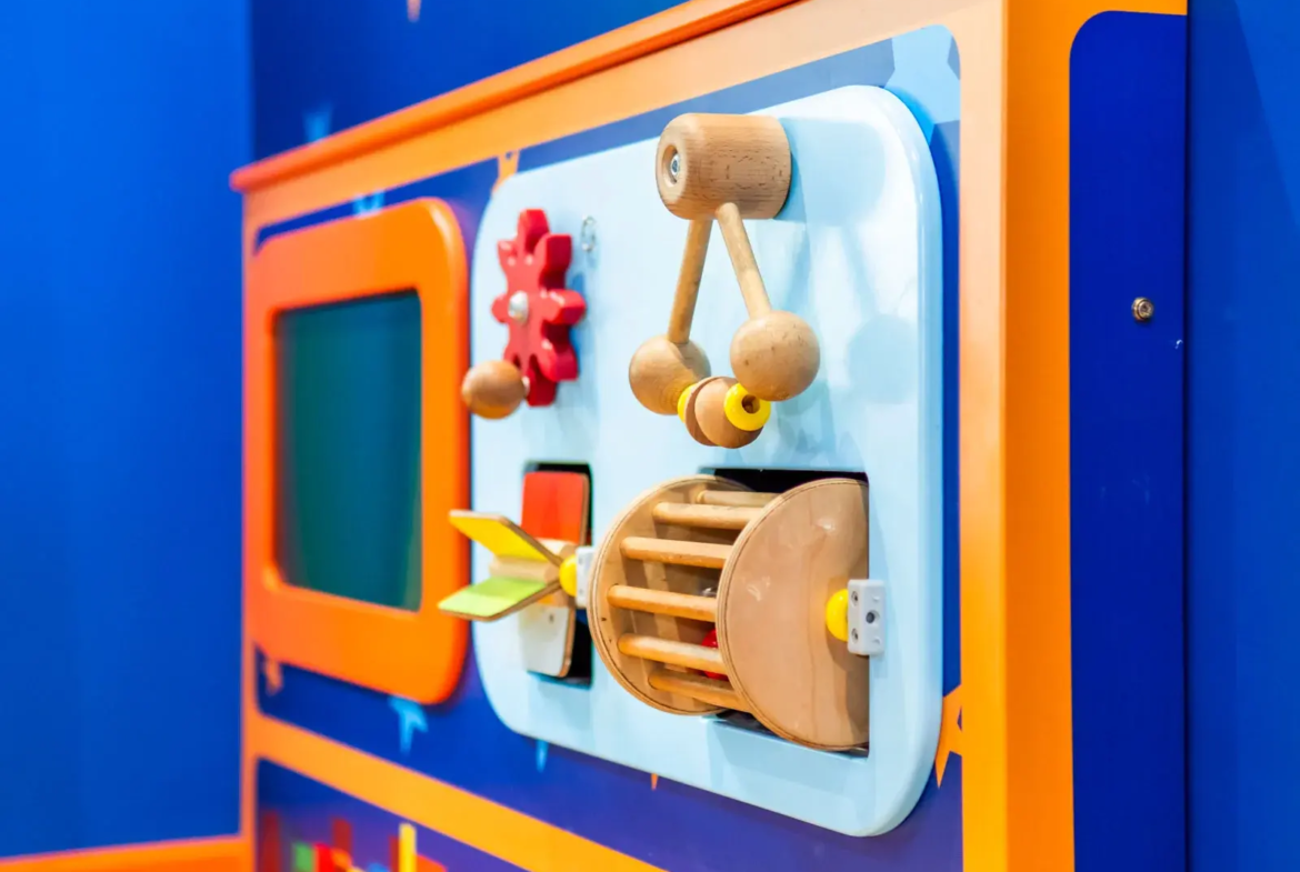 Colourful children's interactive activity wall panel.