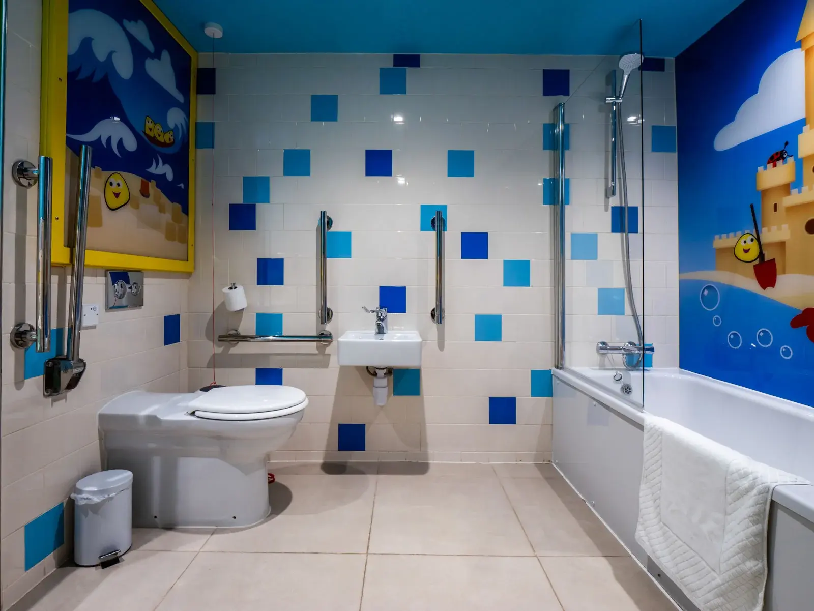 Bright bathroom with blue tile accents and bathtub.