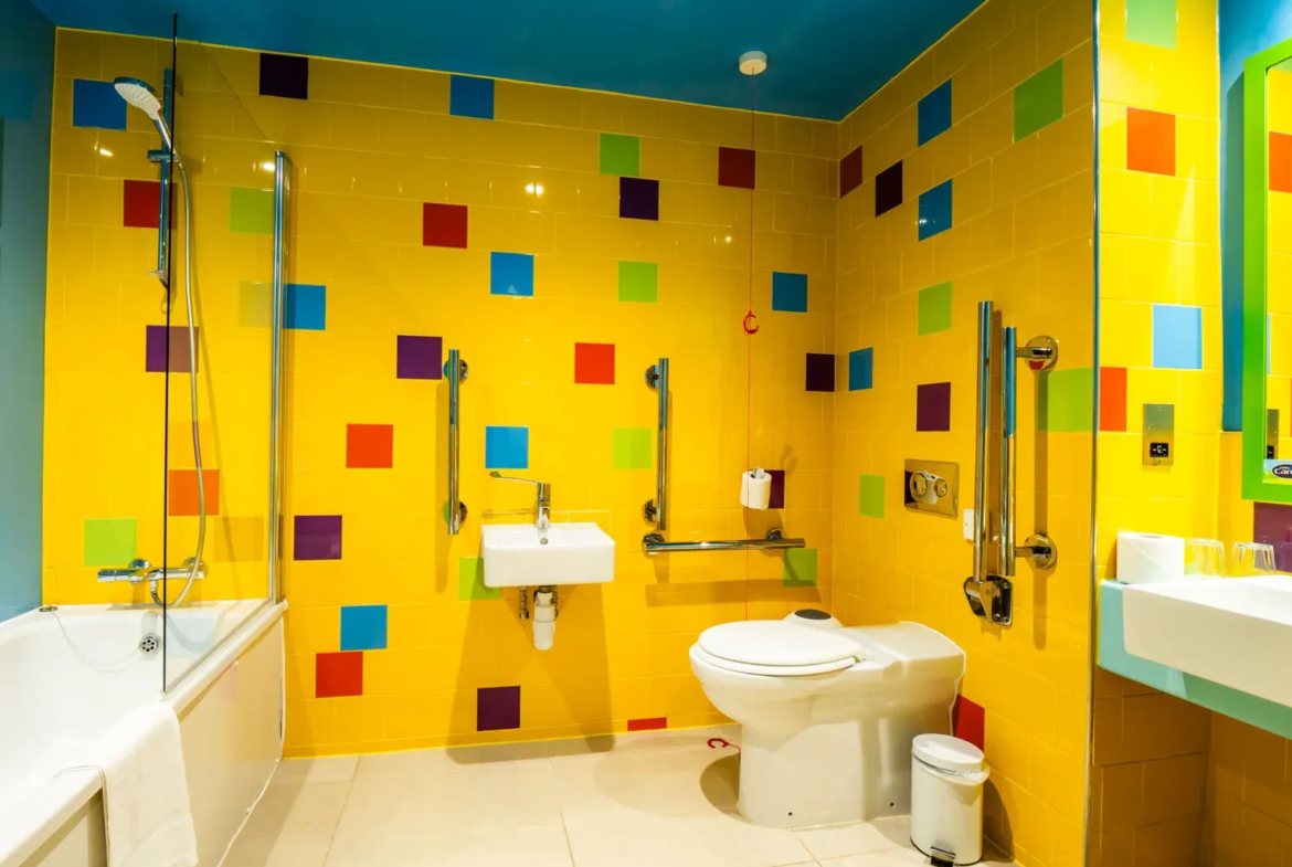 Accessible bathroom with vibrant colourful tiles.