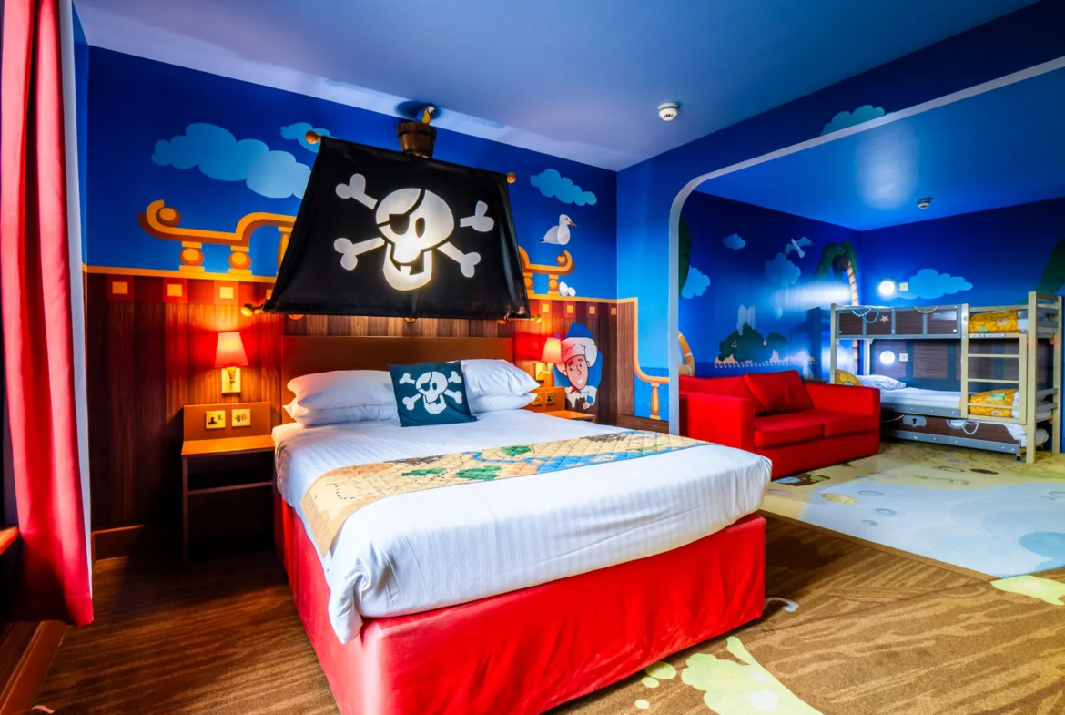 Pirate-themed children's hotel room with bunk beds and decor.