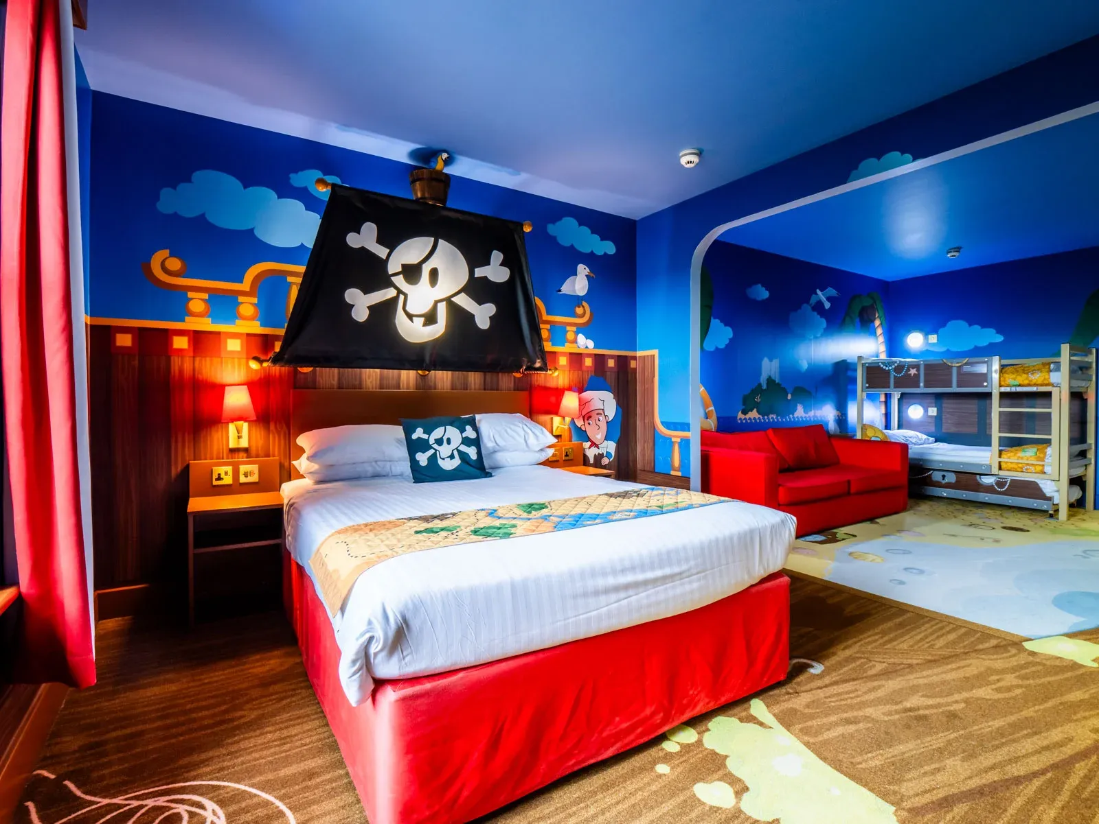 Pirate-themed children's hotel room with bunk beds and decor.