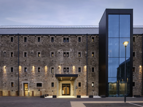Historic brick building with modern glass extension.